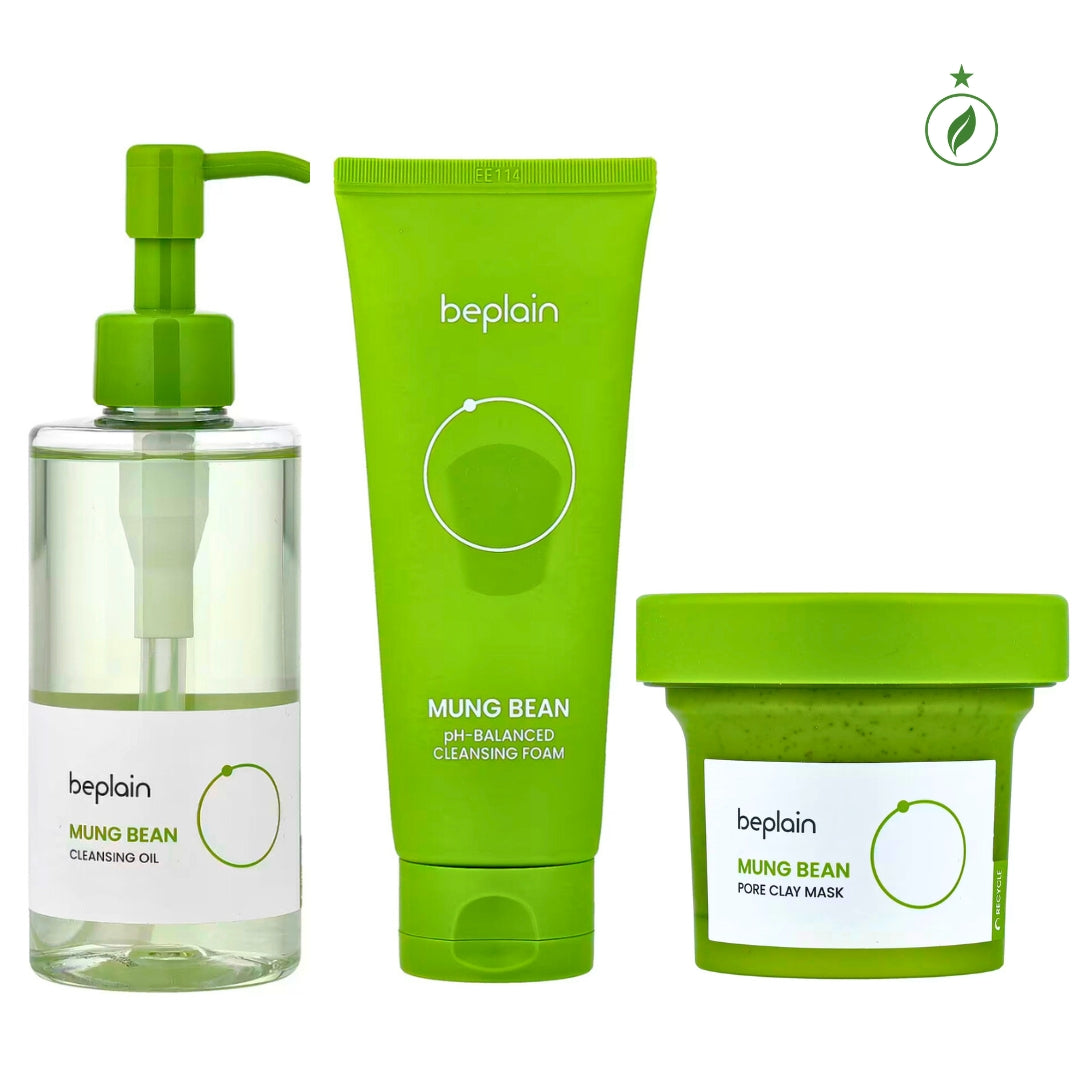 This luxurious Korean Mung Bean Complete Cleansing Set is displayed in a vibrant, nature-inspired scene that highlights its clean-beauty purity and premium botanical origins. The radiant Mung Bean Cleansing Oil stands on the left with a golden-green glow, while the pH-balanced Mung Bean Cleansing Foam rises tall beside it, embodying advanced Korean deep-cleansing innovation. In front, the rich Mung Bean Pore Clay Mask showcases its detoxifying green texture. Modern Korean Skincare, acne fighter.